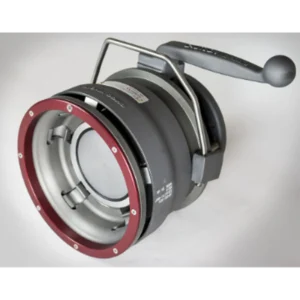 Close-up of a precision mechanical assembly featuring a circular red outer ring, gray inner components, and a metal lever with a rounded knob on the end.